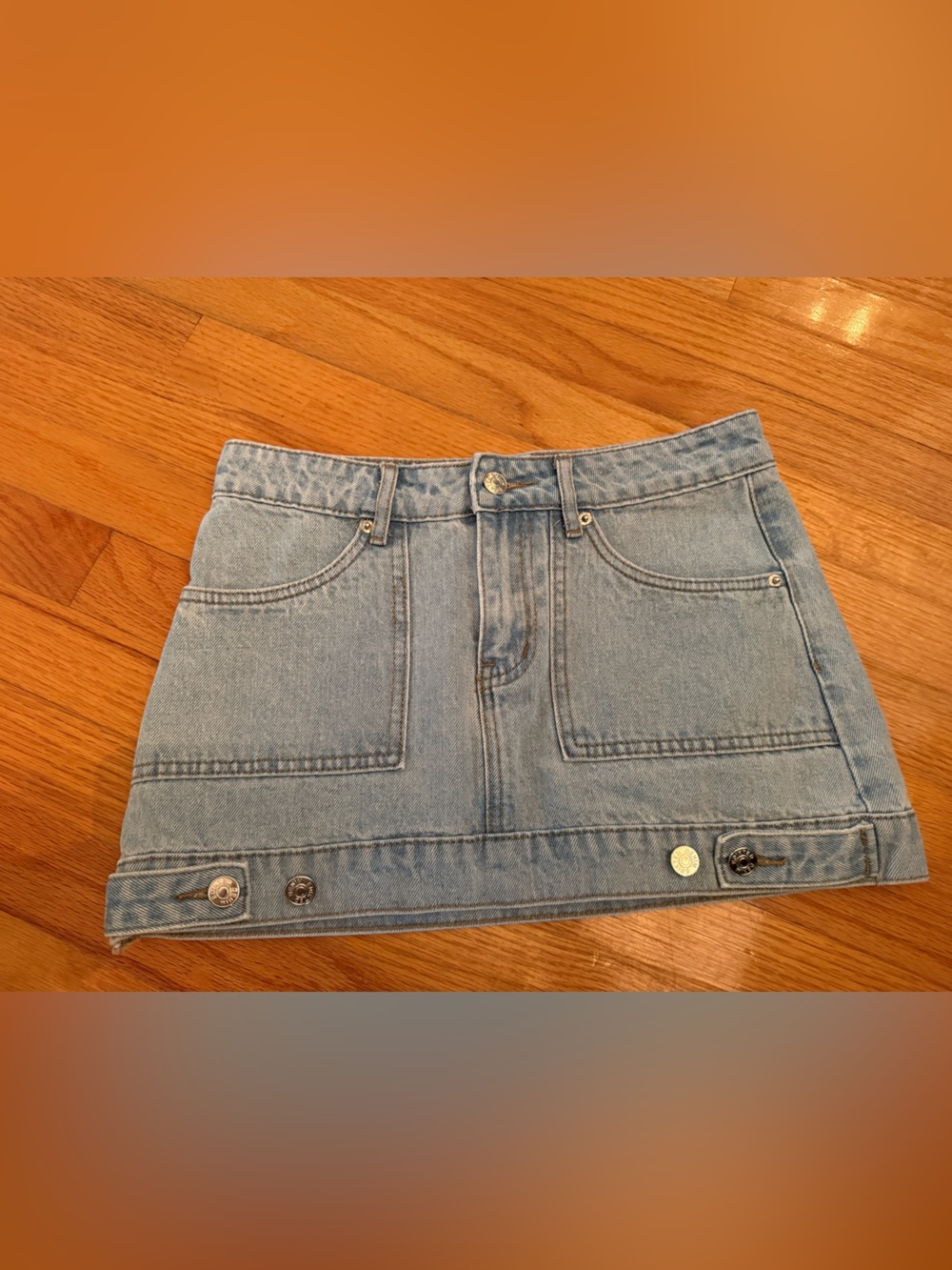 Edikted Light Wash Denim Mini Skirt with Button Hem